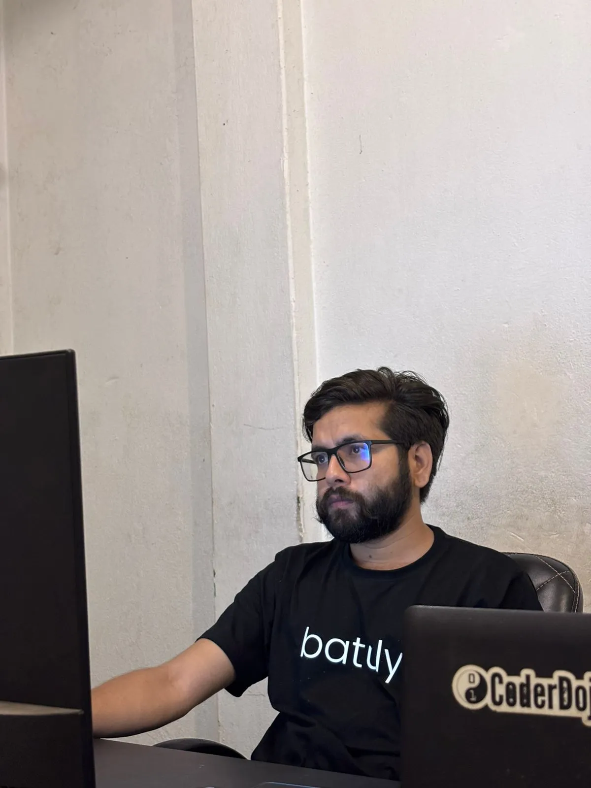 CTO working late at night on a laptop during the startup’s early days.