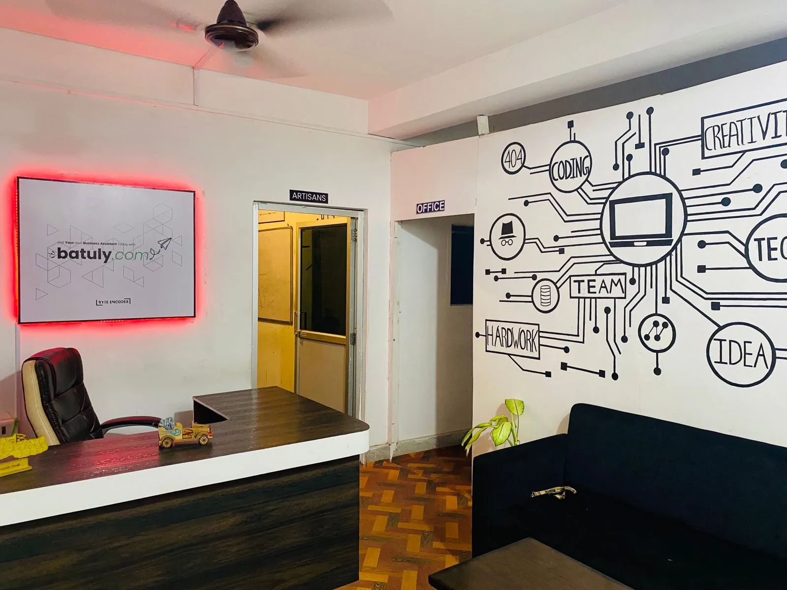 Workspace of Byte Encoder with creative wall illustrations and minimal setup.
