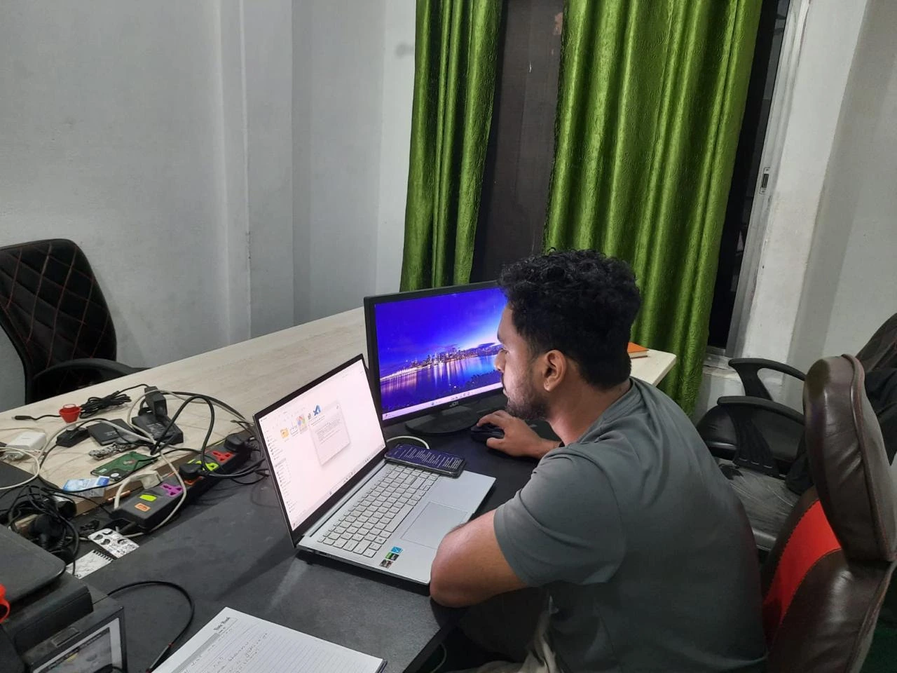 CTO working late at night on a laptop during the startup’s early days.